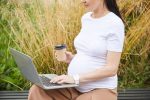 Pregnant woman working on laptop