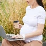 Pregnant woman working on laptop